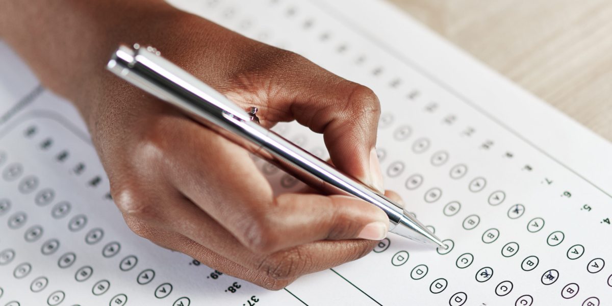 Selecting the best answer. Shot of a person filling in an answer sheet for a test